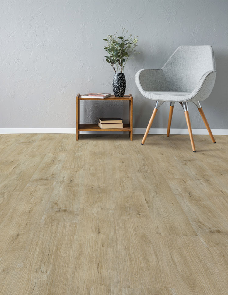 light wood look vinyl flooring in living room with grey chair and black vase on table